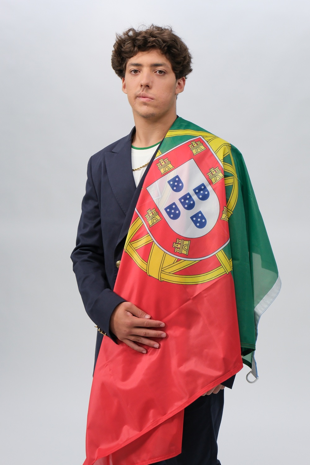 Thomas Augusto Formal Portrait with Portugal Flag Portrait of Thomas Augusto wearing a blazer and draped in the Portugal flag, representing professionalism and pride.