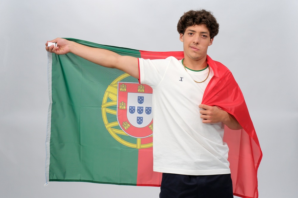 Thomas Augusto with Portugal Flag Portrait Professional skateboarder Thomas Augusto posing with the Portugal flag, showcasing national pride and athlete identity.