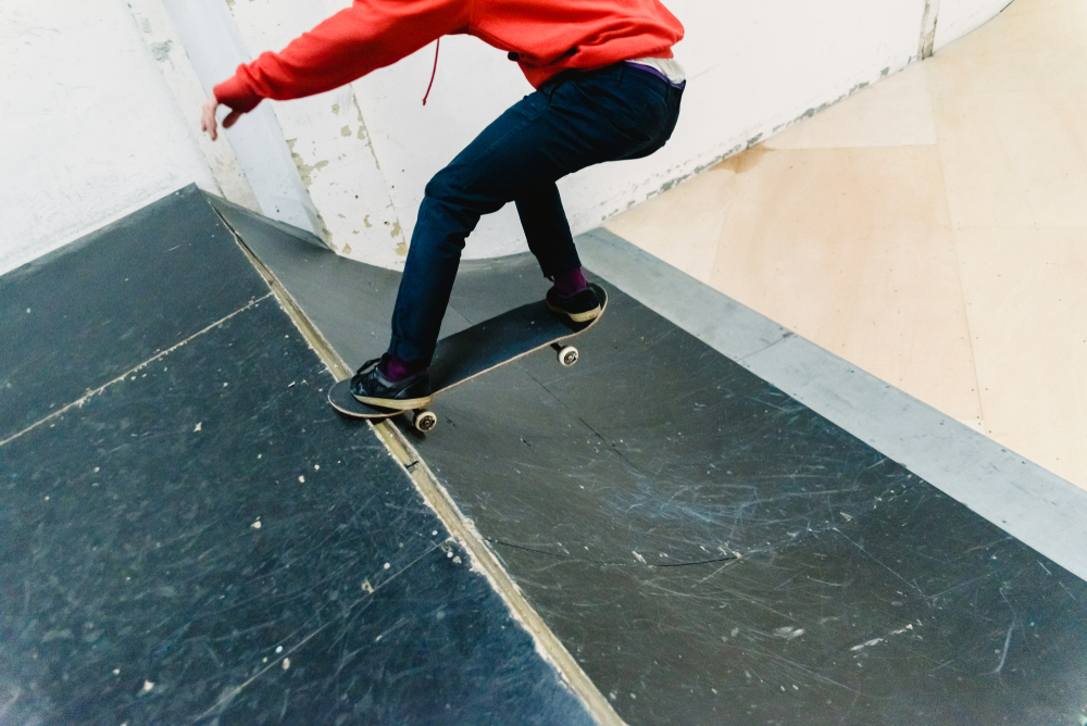 Skateboard Grind Trick on Indoor Ramp - Thomas Augusto Skateboarder grinding along the edge of an indoor ramp, showcasing technique and smooth control. - Thomas Augusto